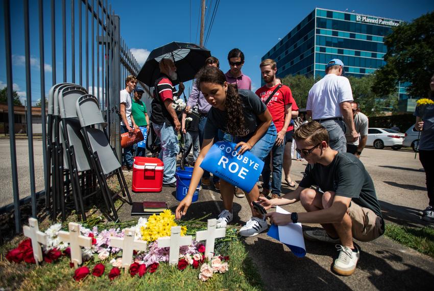People place flowers on a makeshift memorial at a protest in support of the Supreme Court’s decision to overturn Roe v. Wade in front of Planned Parenthood’s offices Saturday, June 25, 2022, in Houston.